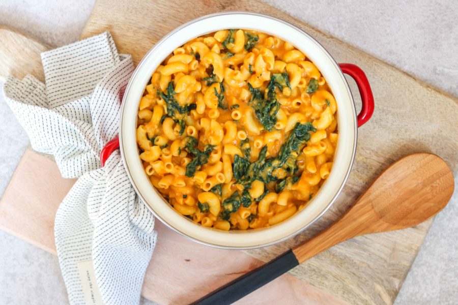 bowl of pumpkin macaroni and cheese with wooden spoon